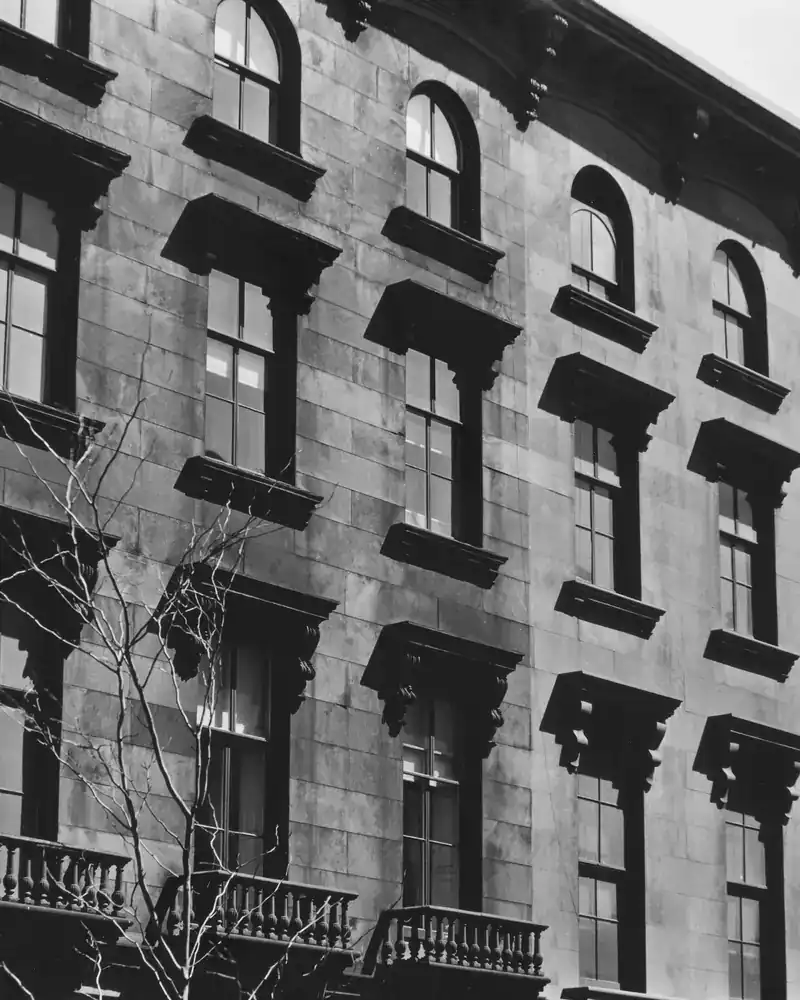 Historic stone row-house facades with arched windows