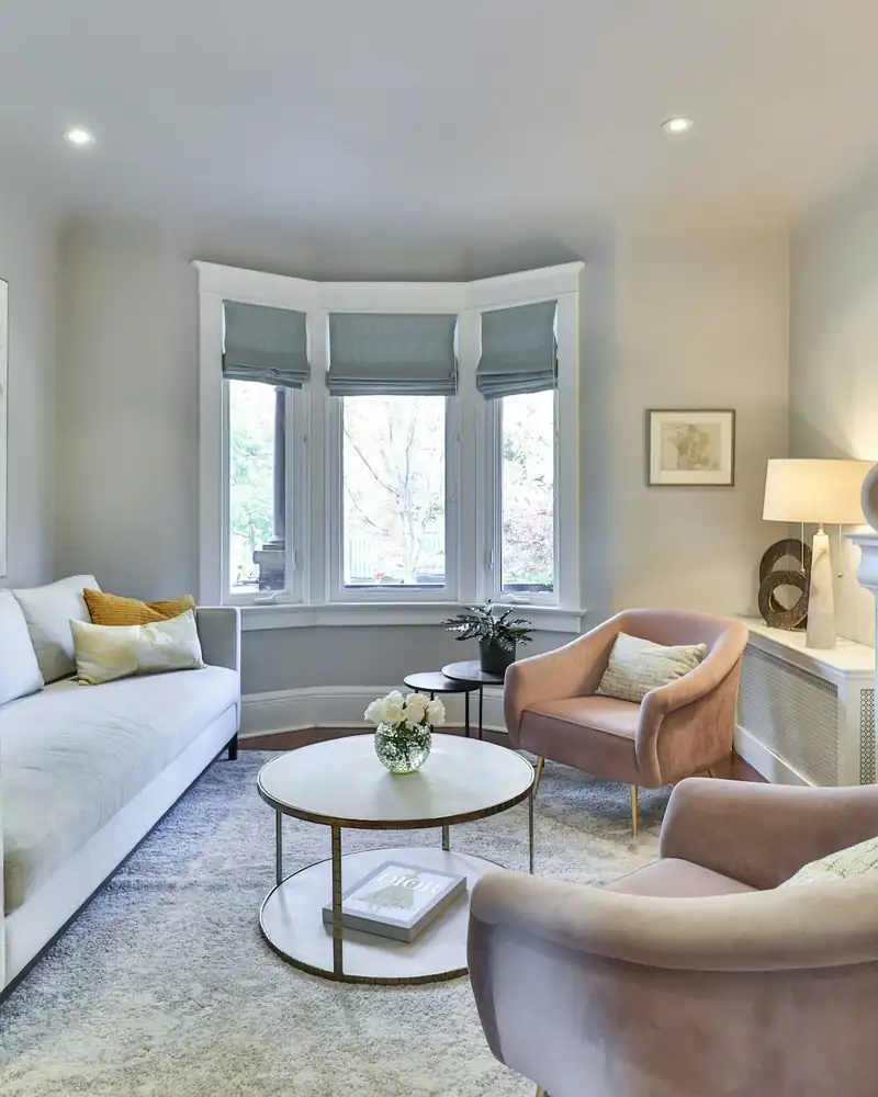 Living room with a marble fireplace and built-in shelves